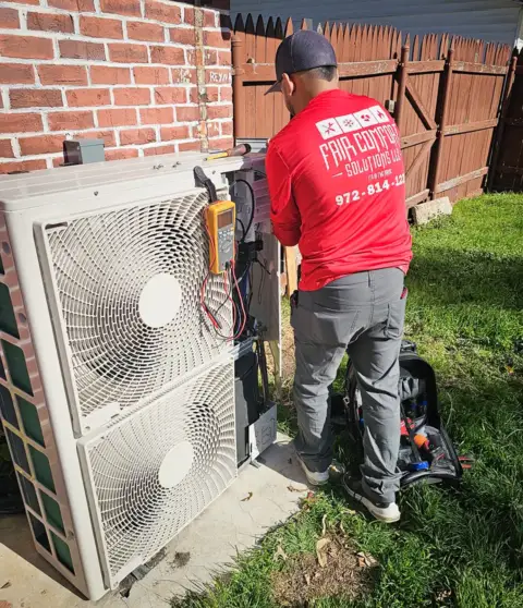 Technician does a routine maintenance on a customer's mini split air conditioner.